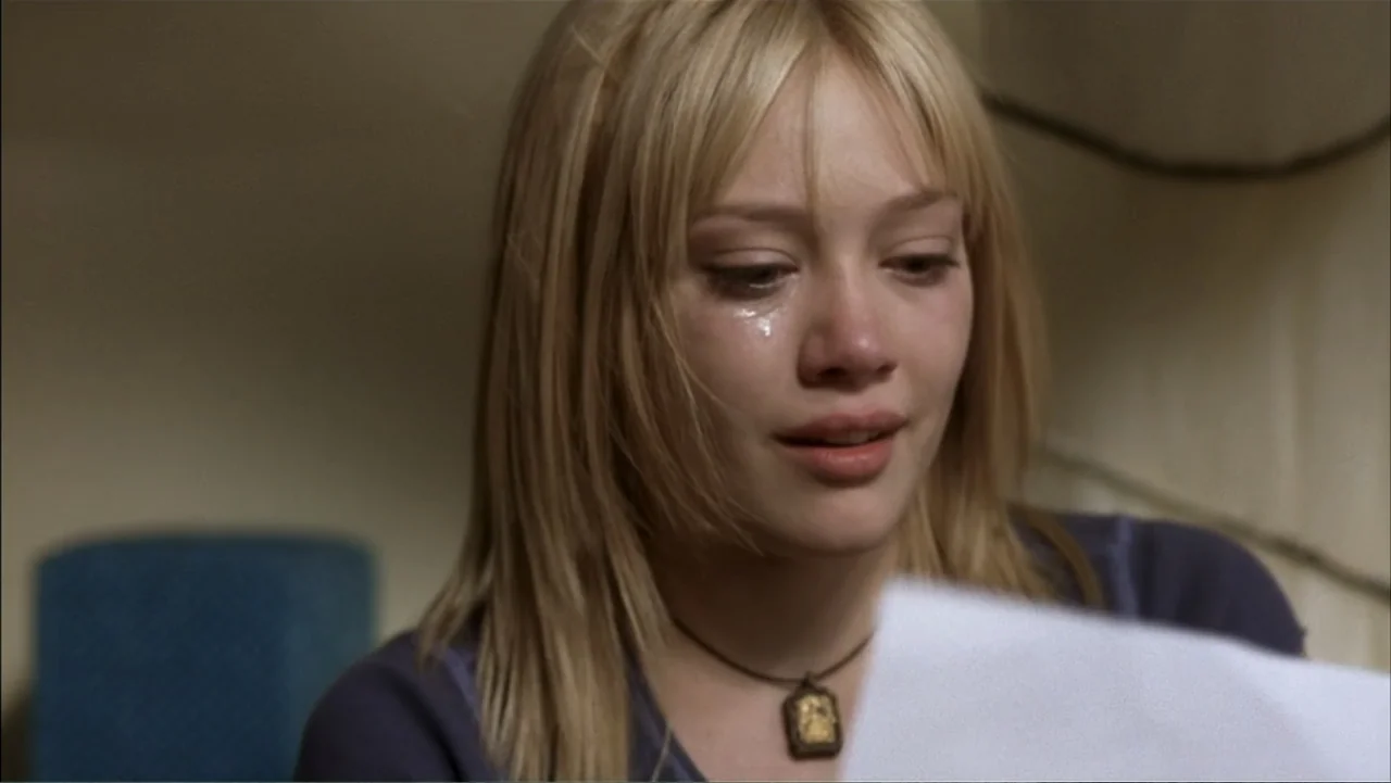 A Cinderella Story (2004) movie still: closeup — A plain interior room with neutral walls provides a muted background for the subject. A young woman…