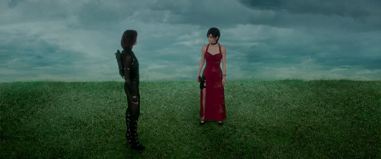 Resident Evil: Retribution (2012) movie still: wide — An open green field stretches toward a vast, overcast, cloud-filled stormy sky. Two women face…