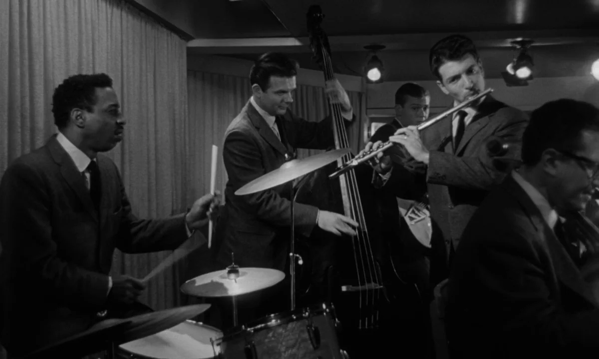 Sweet Smell of Success (1957) movie still: medium — A group of five men perform as a jazz ensemble on a small stage. They play drums, upright bass,…