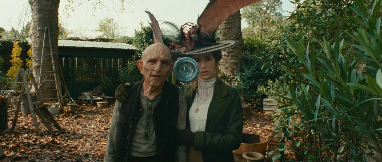 The Extraordinary Adventures of Adèle Blanc-Sec (2010) movie still: medium — A cluttered backyard is filled with wooden ladders, planters, and…