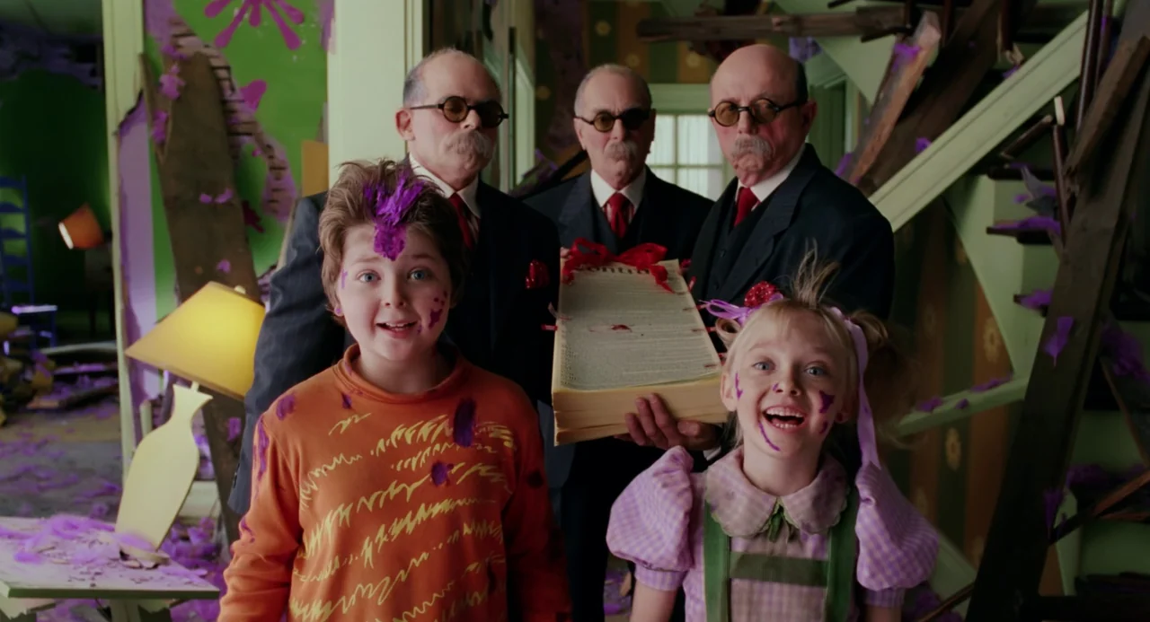 The Cat In The Hat (2003) movie still: medium — A cluttered, whimsical room features lime-green walls covered in purple abstract splatter art. Three…
