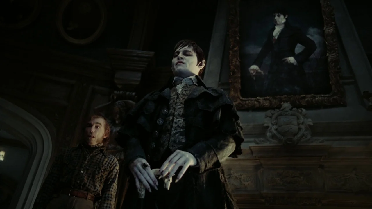Dark Shadows (2012) movie still: medium — A dimly lit room with dark wood paneling and a large framed portrait hanging. The pale man stands before…