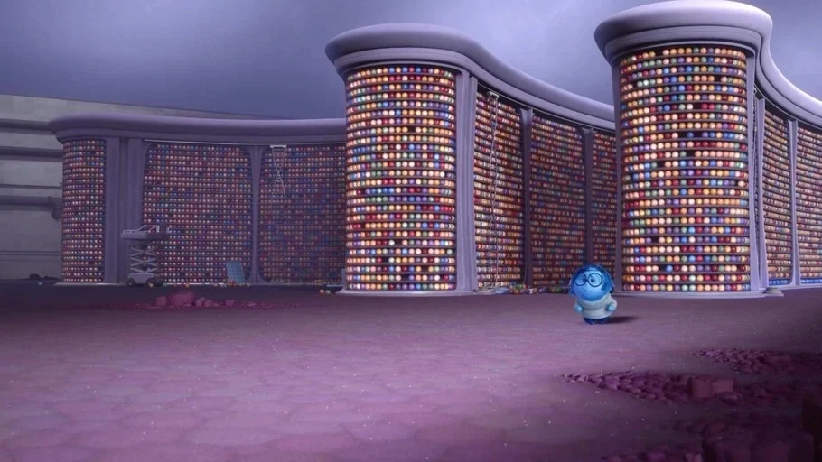Inside Out (2015) movie still: wide — A vast room filled with curved, floor-to-ceiling shelves holding thousands of colored memory orbs. A small…