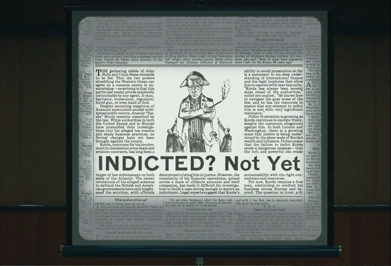 The Phoenician Scheme (2025) movie still: medium — A projection screen displays a mock newspaper page featuring a headline and illustration. The…