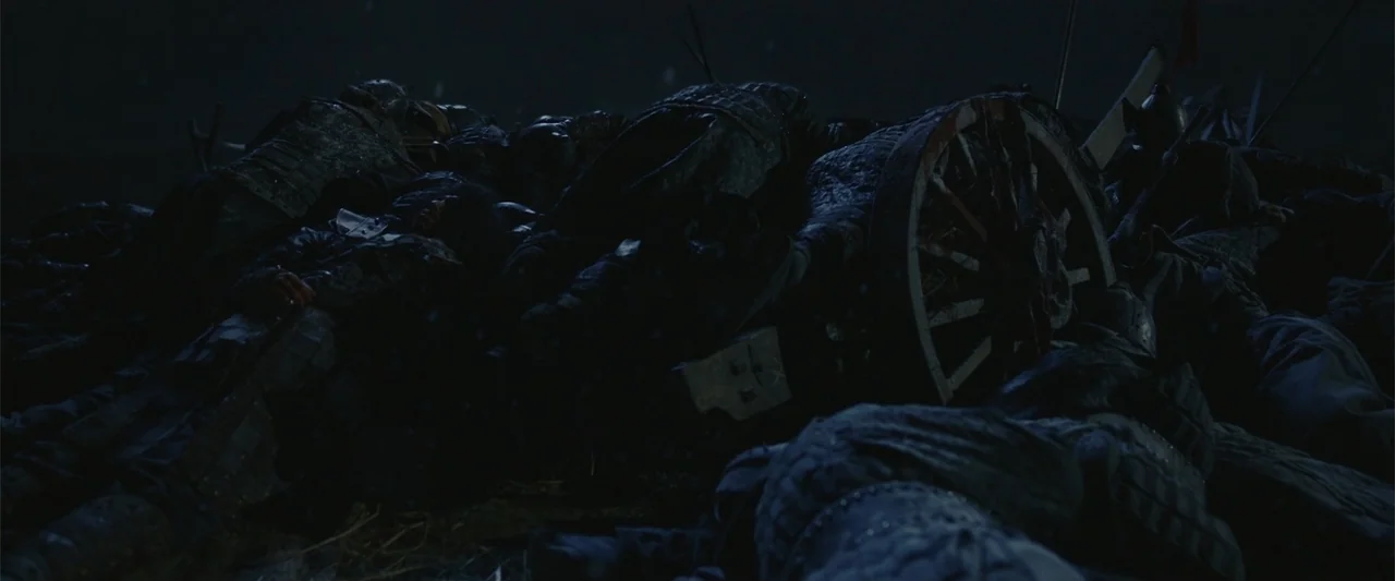 Along with the Gods: The Last 49 Days (2018) movie still: wide — A dark night battlefield shows piles of bodies wearing armor strewn across the…