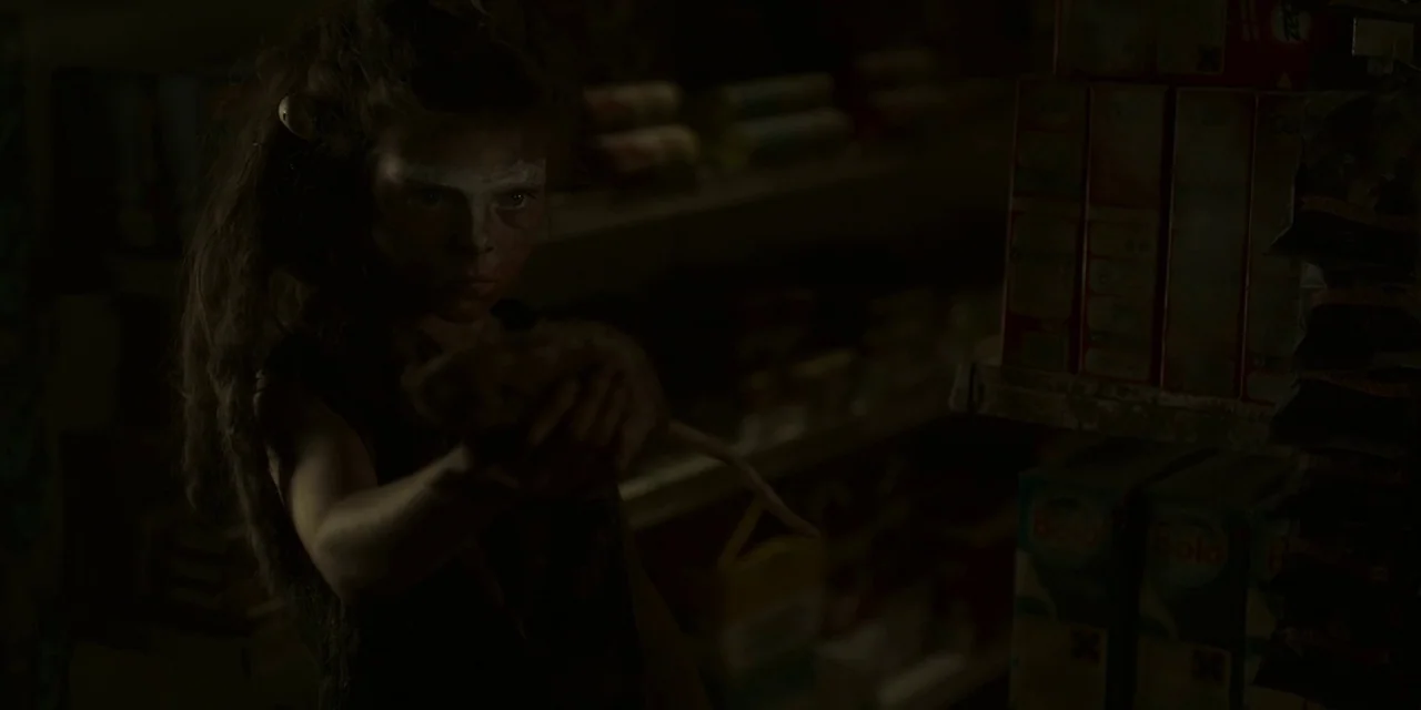 The Girl With All The Gifts (2016) movie still: medium — A dimly lit pantry interior features shelves stocked with various boxes and packaged goods.…