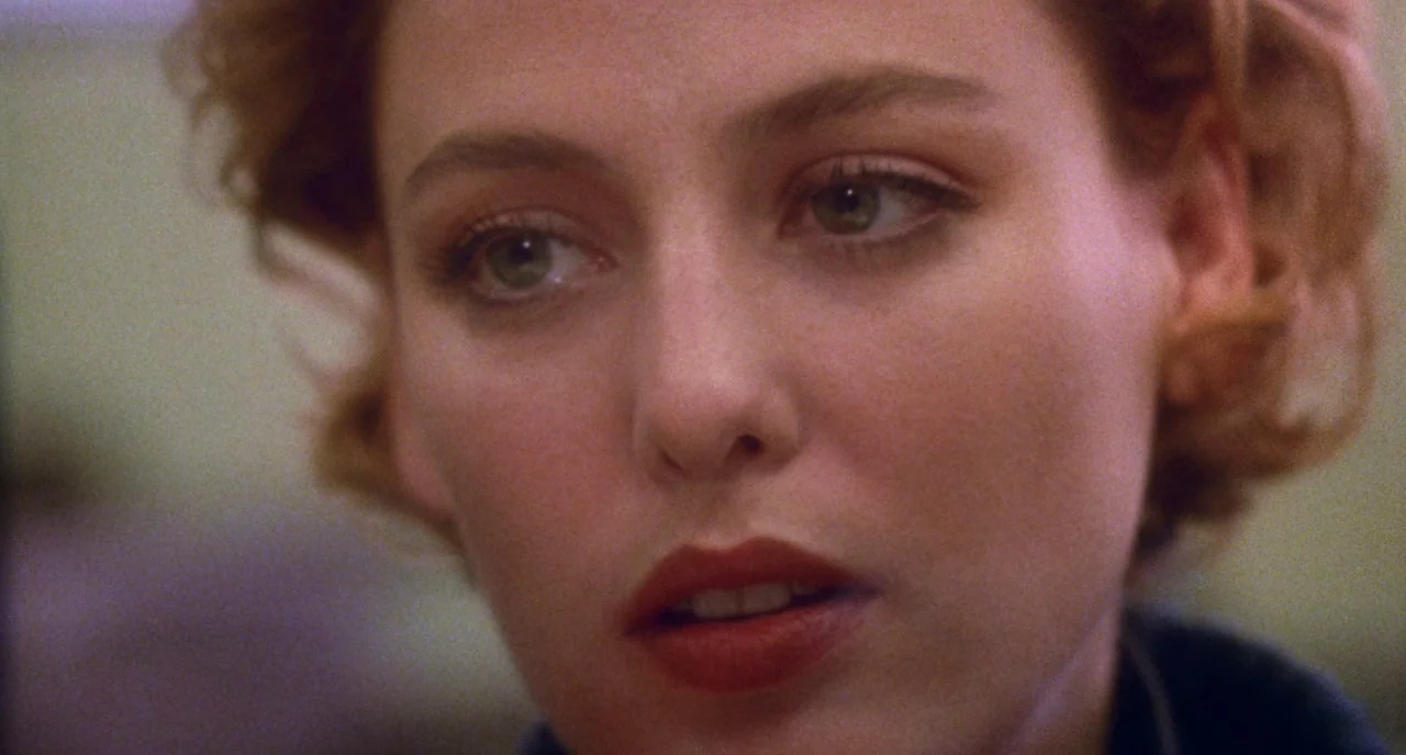 Candyman (1992) movie still: closeup — A close portrait of a young woman in an indoor space. The subject stares off-screen while her facial features…