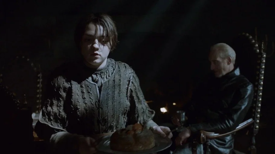 Game of Thrones: The Last Watch (2019) movie still: medium — A dimly lit stone room features a fire-lit interior with heavy shadows. A young girl…