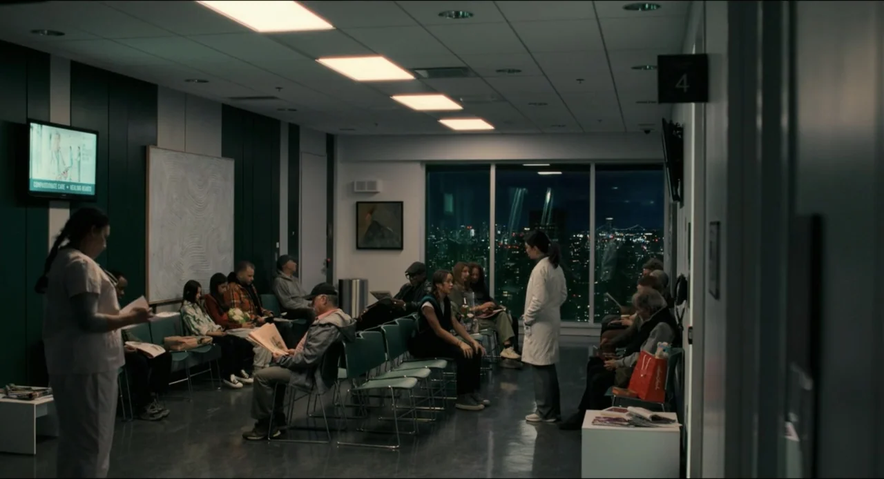 Karate Kid: Legends (2025) movie still: wide — A modern hospital waiting area features rows of green chairs and large floor-to-ceiling windows.…