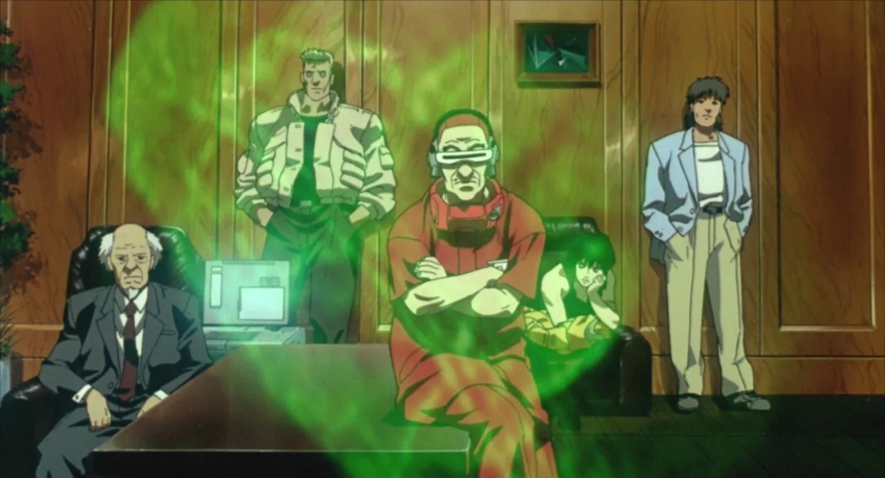 Ghost in the Shell (1995) movie still: medium — A wood-paneled room houses five people gathered around a table with a computer. A swirling green…