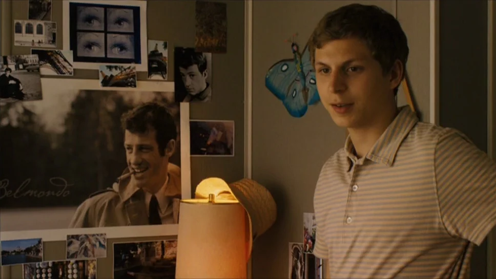 Youth In Revolt (2009) movie still: medium — A bedroom wall is covered in various black and white photographs and movie posters. A young man stands…