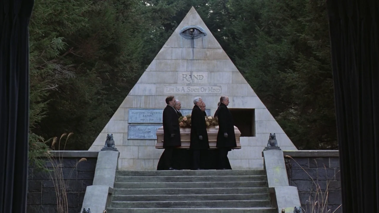 Being There (1979) movie still: wide — A stone pyramid mausoleum features an eye symbol and inscription set within a forest. Several men in dark…