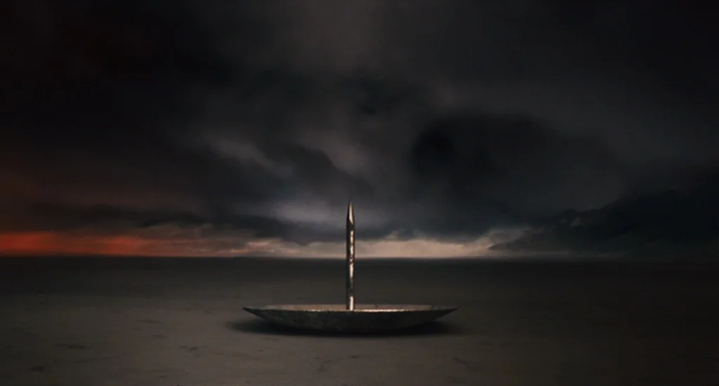 The Imaginarium of Doctor Parnassus (2009) movie still: wide — A dark, empty plain stretches out under a massive, cloud-covered night sky. A…