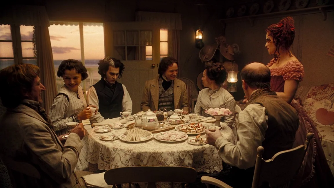 Sweeney Todd: The Demon Barber of Fleet Street (2007) movie still: wide — A cozy tea party occurs in a wood-paneled room during a sunset. Multiple…