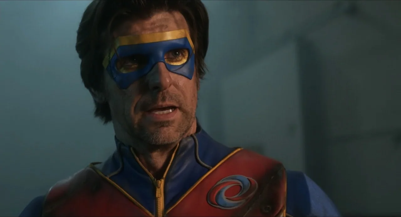 Henry Danger: The Movie (2025) movie still: closeup — A dimly lit room with grey walls frames the subject in a tight shot. A man in a blue and red…