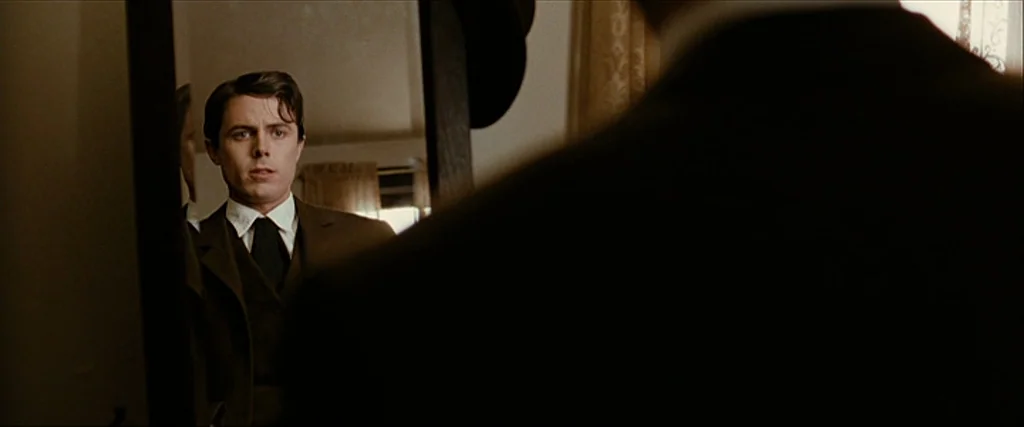 The Assassination Of Jesse James By The Coward Robert Ford (2007) movie still: medium — An interior space contains a dark wooden-framed mirror…