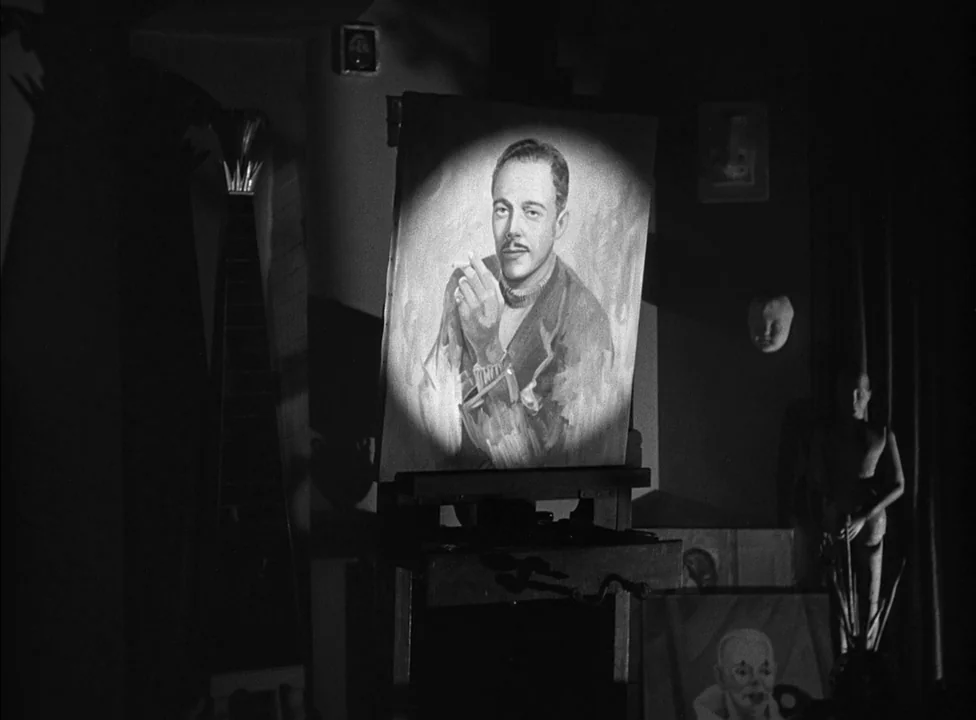 Murder, My Sweet (1944) movie still: medium — A dimly lit art studio features various canvases and a mannequin in the background. A spotlight shines…