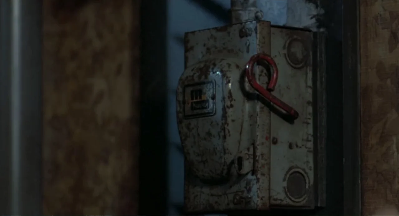 An Experiment in Fear: The Making of Monkey Shines (2014) movie still: closeup — A vintage metal electrical switch box is mounted against a…