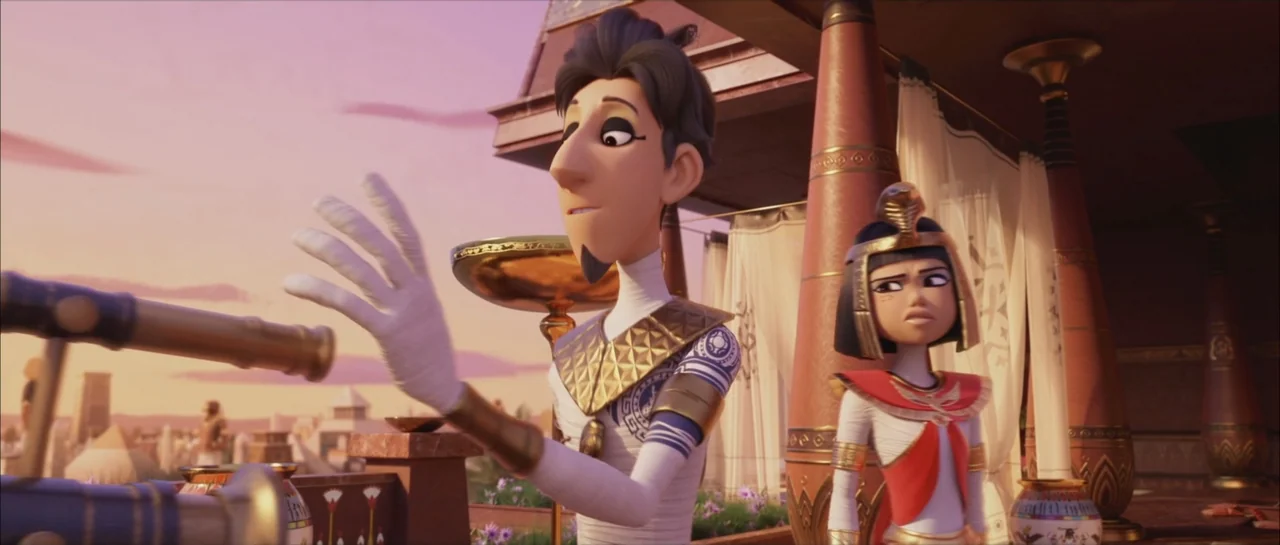 Mummies (2023) movie still: medium — A sunny outdoor balcony with classic Egyptian columns and fabric curtains overlooking a city. A man points at a…