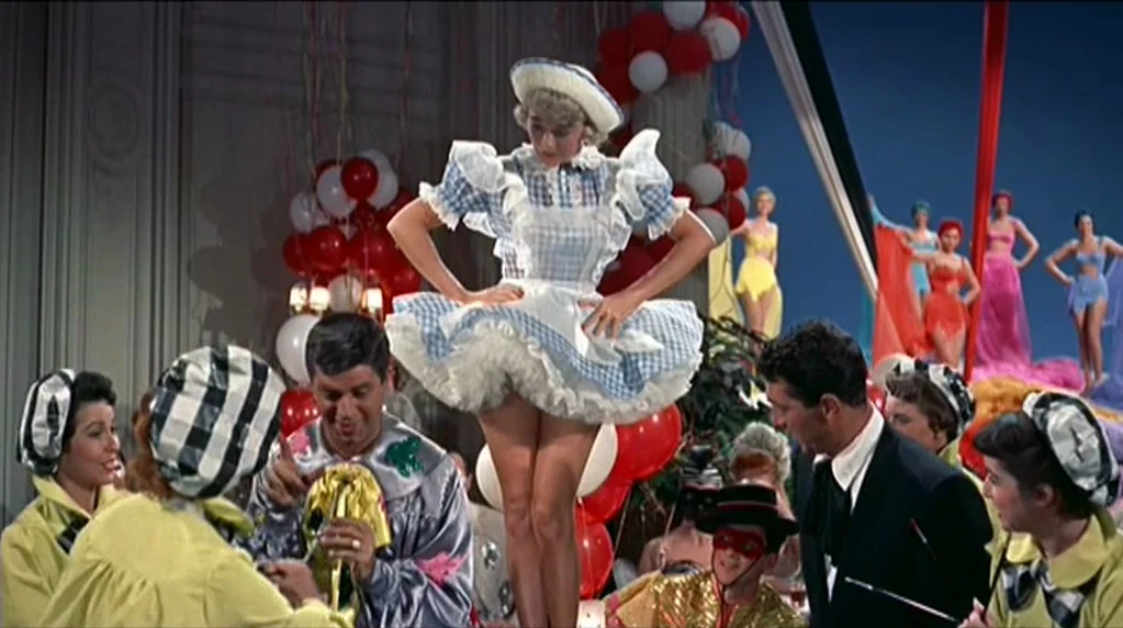 Artists and Models (1955) movie still: medium — A festive ballroom setting decorated with white and red balloons and streamers. A woman in a gingham…