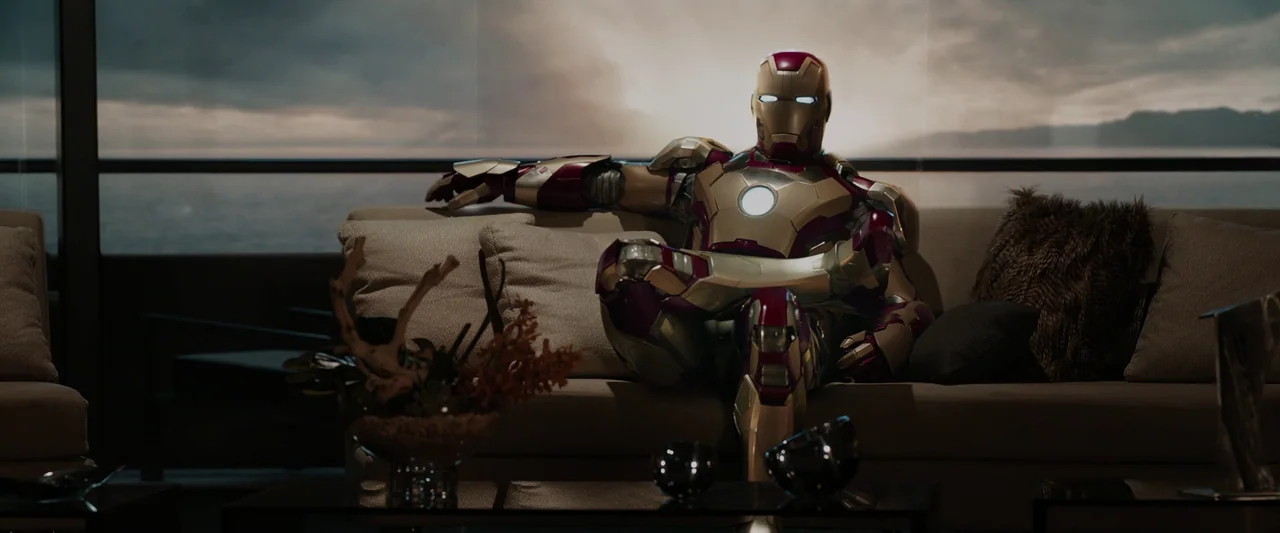 Iron Man 3 (2013) movie still: medium — A luxury apartment overlooks a large body of water through floor-to-ceiling glass windows. A figure in a…