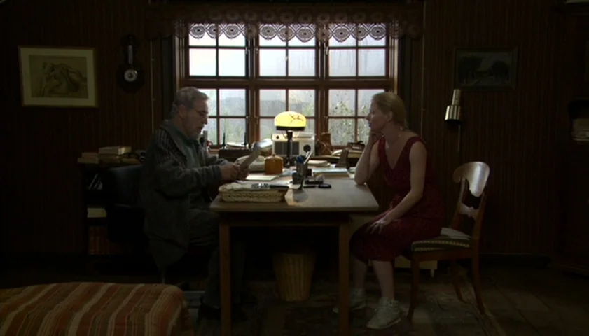 Saraband (2003) movie still: wide — A wood-paneled office features a large window with a patterned curtain and framed artwork. An older man and a…