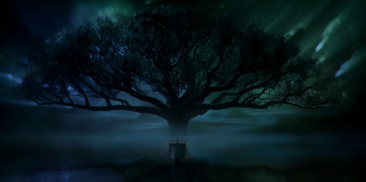 The Northman (2022) movie still: wide — A massive, sprawling tree stands in the center of a calm, dark water surface. Dense low-lying fog surrounds…