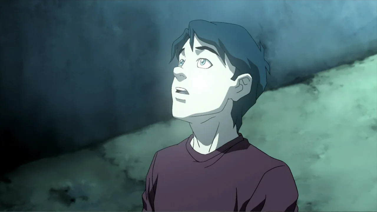 Superman/Shazam!: The Return of Black Adam (2010) movie still: medium — An adolescent boy stands in a dark, textured corridor with angled concrete…