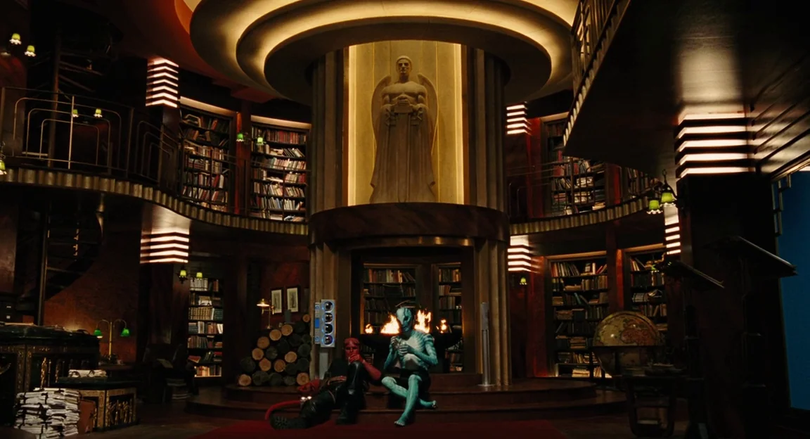 Hellboy II: The Golden Army (2008) movie still: wide — A spacious, multi-level circular library features a massive stone statue built into a pillar.…