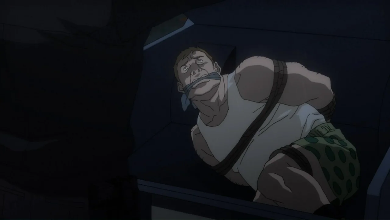 Batman: Assault on Arkham (2014) movie still: medium — A dark vehicle interior with a man confined in the back seat area. The subject is tied with…