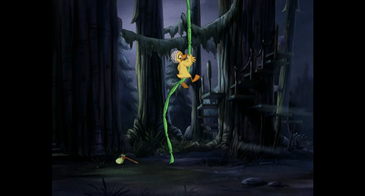The Sissy Duckling (1999) movie still: fullbody — A dark swamp environment features massive gnarled trees and a winding wooden staircase. A yellow…