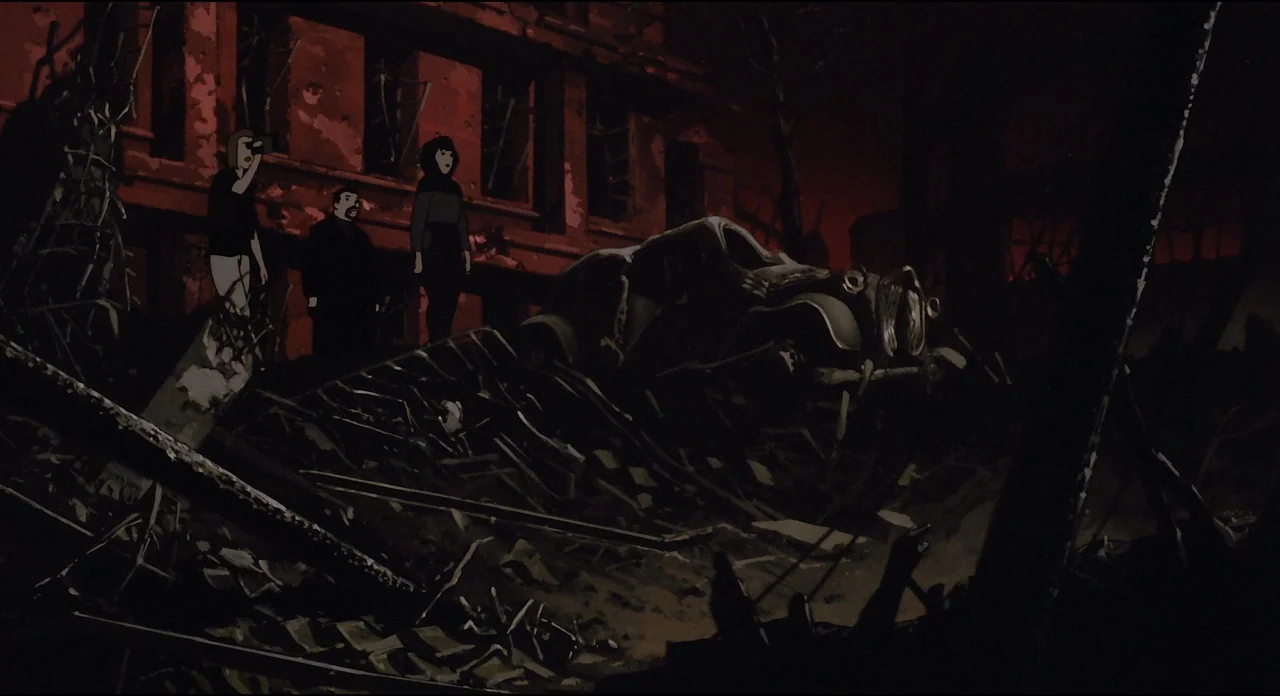 Millenium Actress (2001) movie still: wide — A decimated urban street features piles of debris and a wrecked vintage car. Three people stand amidst…