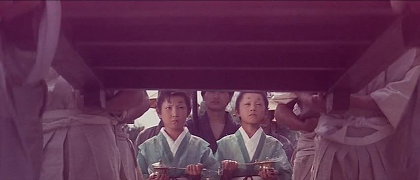 Lone Wolf and Cub: Baby Cart in the Land of Demons (1973) movie still: medium — A group of people in traditional East Asian attire walk together in…