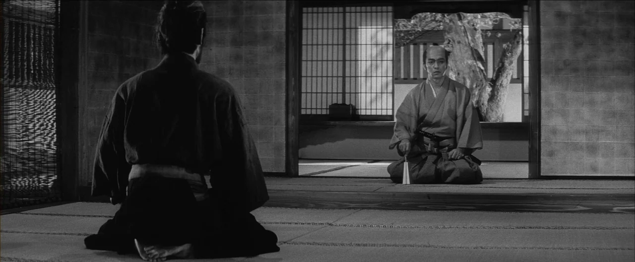 Harakiri (1962) movie still: medium — A traditional Japanese interior with tatami flooring and shoji screens overlooking a courtyard tree. Two men…