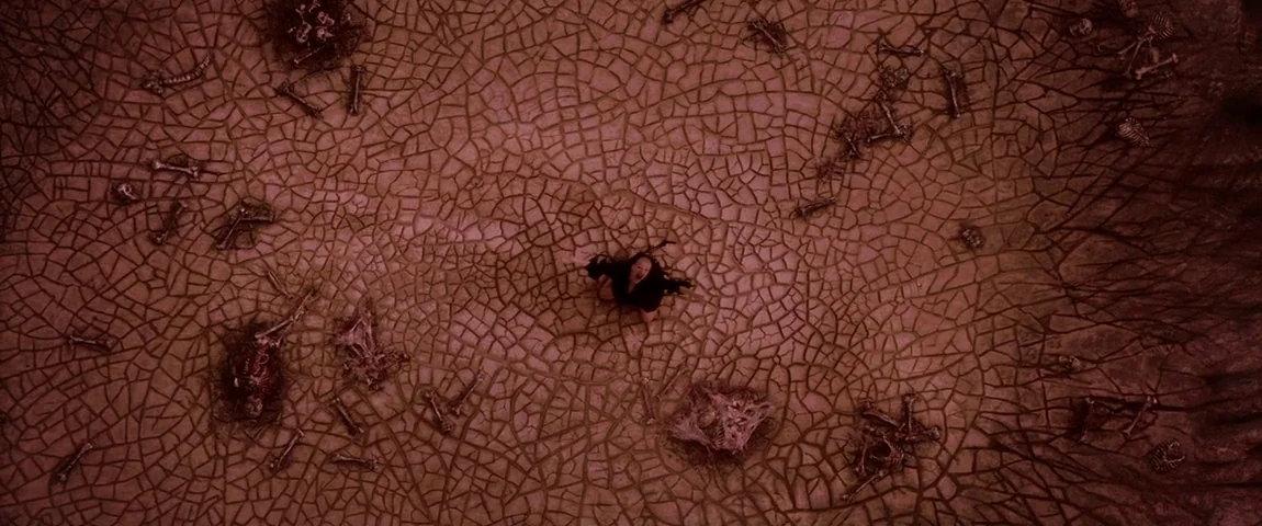 The Passion of the Christ (2004) movie still: wide — A vast expanse of parched, cracked earth covered with scattered human remains and skeletons. A…