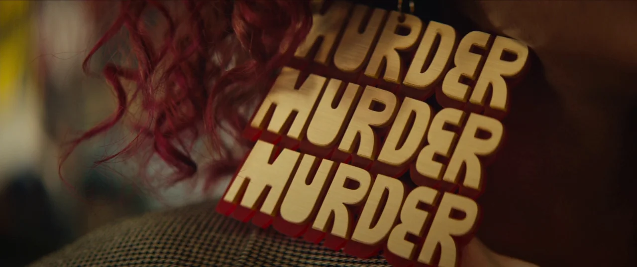 Sorry to Bother You (2018) movie still: closeup — A close-up view focuses on a person wearing a large, layered wooden statement earring. The…