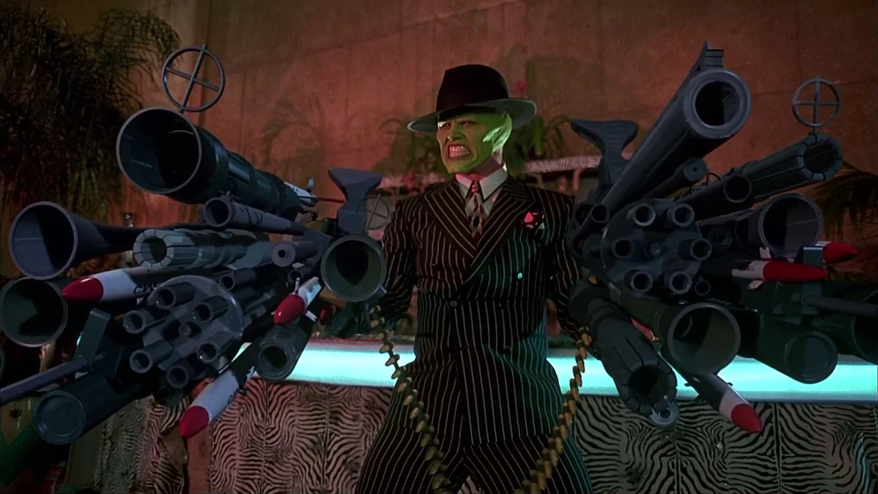 The Mask (1994) movie still: medium — A nightclub interior features a bright cyan neon strip against a textured backdrop. A character with green…