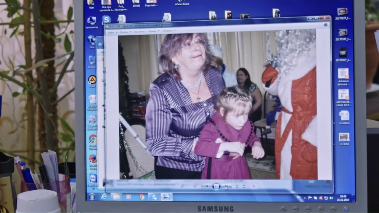 Finding the Way Home (1991) movie still: medium — A computer monitor displays a photograph of a woman and child inside an office. The screen shows…