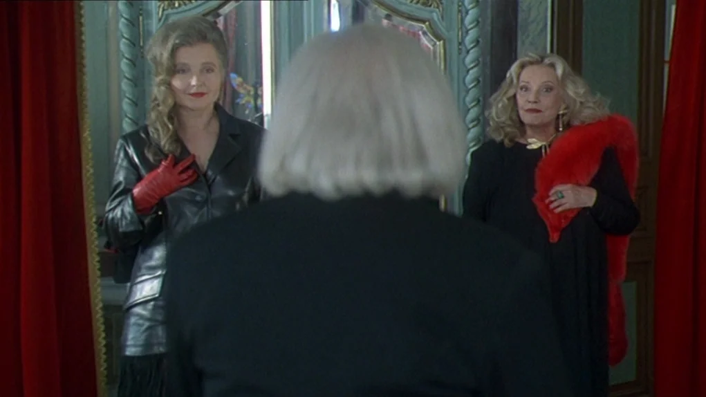One Hundred and One Nights (1995) movie still: medium — A room with large ornate mirrors reflects two women in formal attire. The subject in the…
