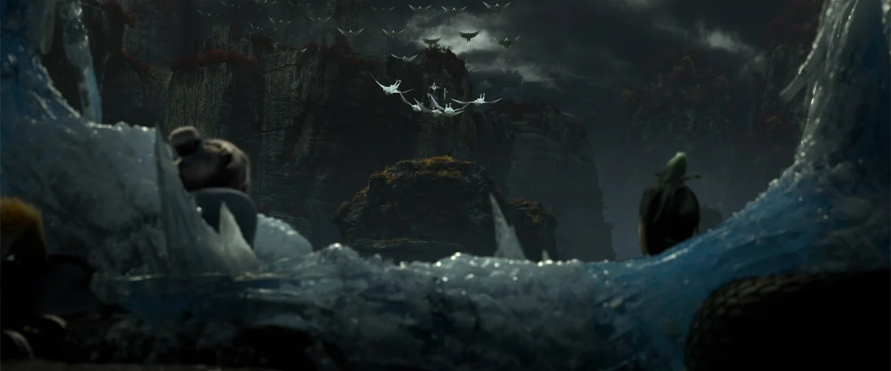 White Snake (2019) movie still: wide — Jagged dark mountain cliffs rise under a stormy night sky filled with clouds. A woman stands in the…