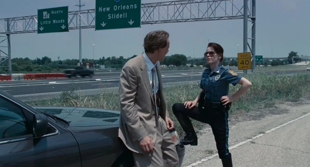 Bad Lieutenant: Port Of Call New Orleans (2009) movie still: medium — A highway shoulder with road signs indicating exits for New Orleans and…
