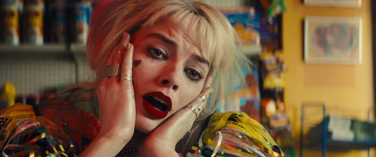 Birds of Prey (and the Fantabulous Emancipation of One Harley Quinn) (2020) movie still: closeup — A cluttered retail aisle with blurred shelving…