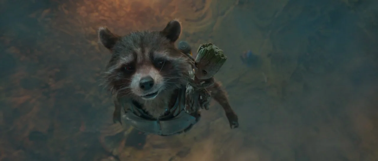 Guardians of the Galaxy Vol. 2 (2017) movie still: medium — The background consists of a dark, debris-filled, and smoky terrain at night. A raccoon…