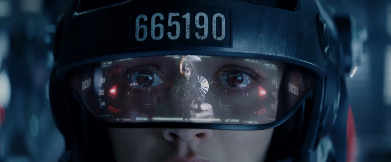 Ready Player One (2018) movie still: closeup — A high-tech pilot helmet with a transparent digital visor obscures most of the face. The visor…