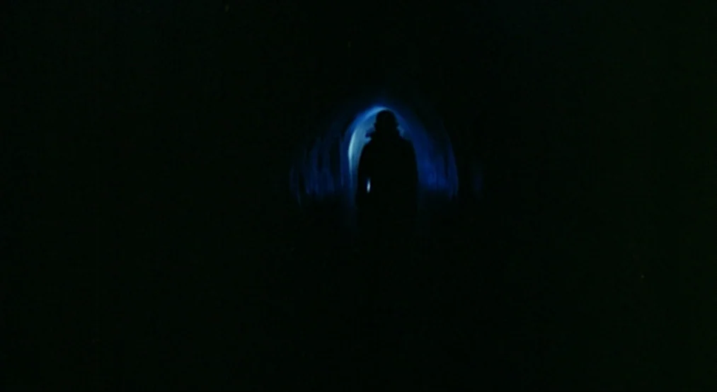 Nosferatu the Vampyre (Nosferatu Phantom Der Nacht) (1979) movie still: wide — A dark, narrow tunnel transitions into a small point of bright blue…