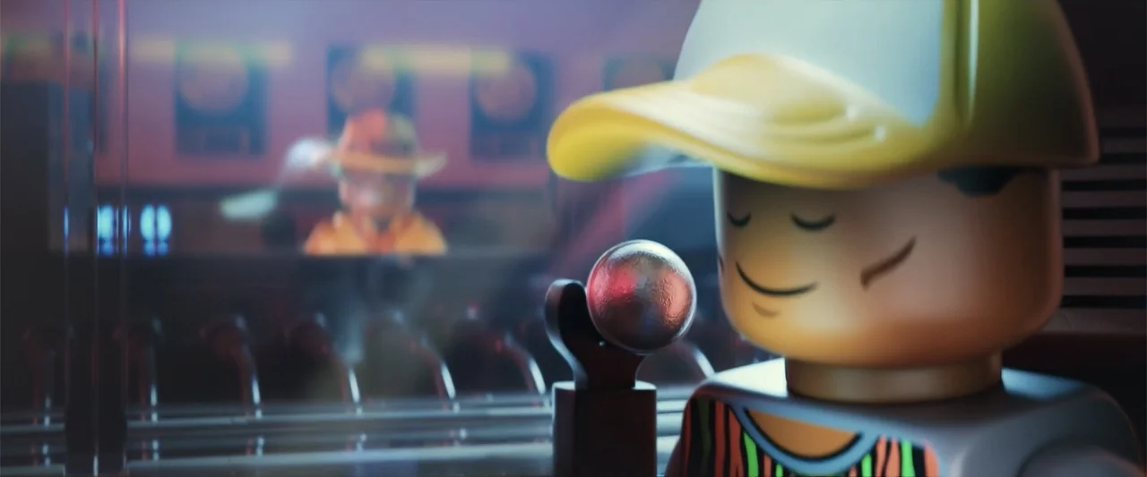 Piece by Piece (2024) movie still: closeup — A recording studio interior features a yellow plastic toy minifigure near a silver microphone. The…