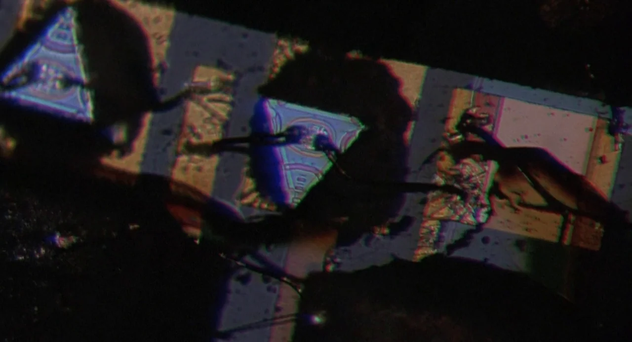 Silent Running (1972) movie still: closeup — An abstract, glitch-heavy digital frame displays repeating triangular symbols with strong chromatic…
