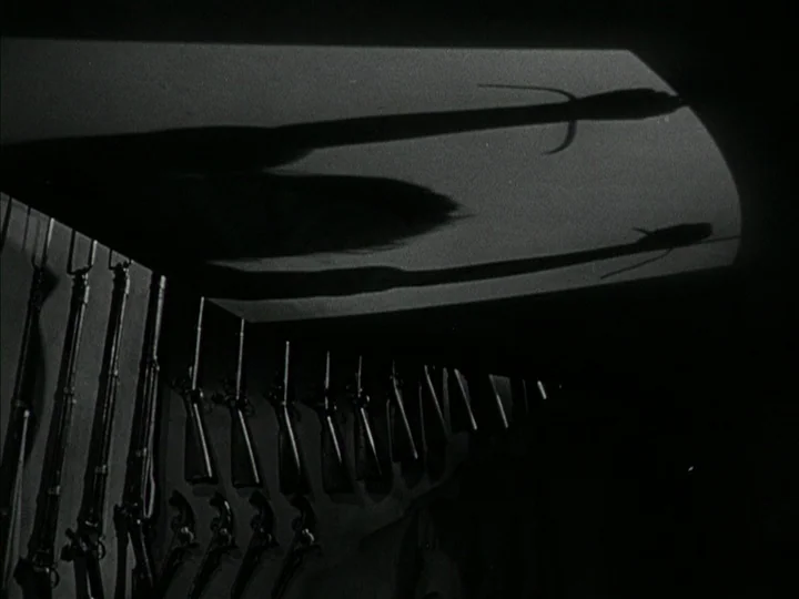 The Black Book (Reign of Terror) (1949) movie still: wide — A dark armory features rows of rifles mounted on the wall. Distorted shadows of objects…