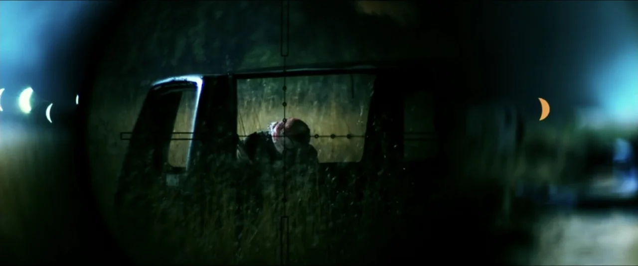 13 Hours: The Secret Soldiers of Benghazi (2016) movie still: medium — A field at night is viewed through the dark circular reticle of a sniper…