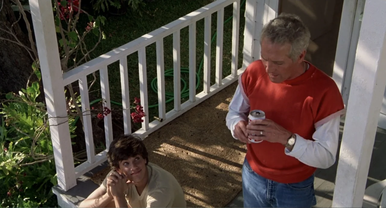 Harry and the Butler (1961) movie still: medium — A wooden porch with a white railing overlooks a green yard with foliage. An older man stands while…